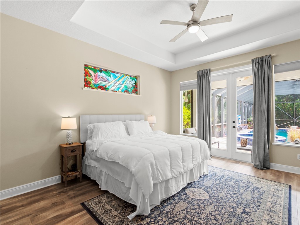 4676 Pebble Bay South, Unit BAY Vero Beach, FL 32963 - Photo 20 of 36 a bedroom with a bed lamps and window