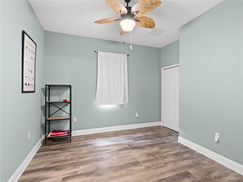 4676 Pebble Bay South, Unit BAY Vero Beach, FL 32963 - Photo 24 of 36 wooden floor in an empty room with a window