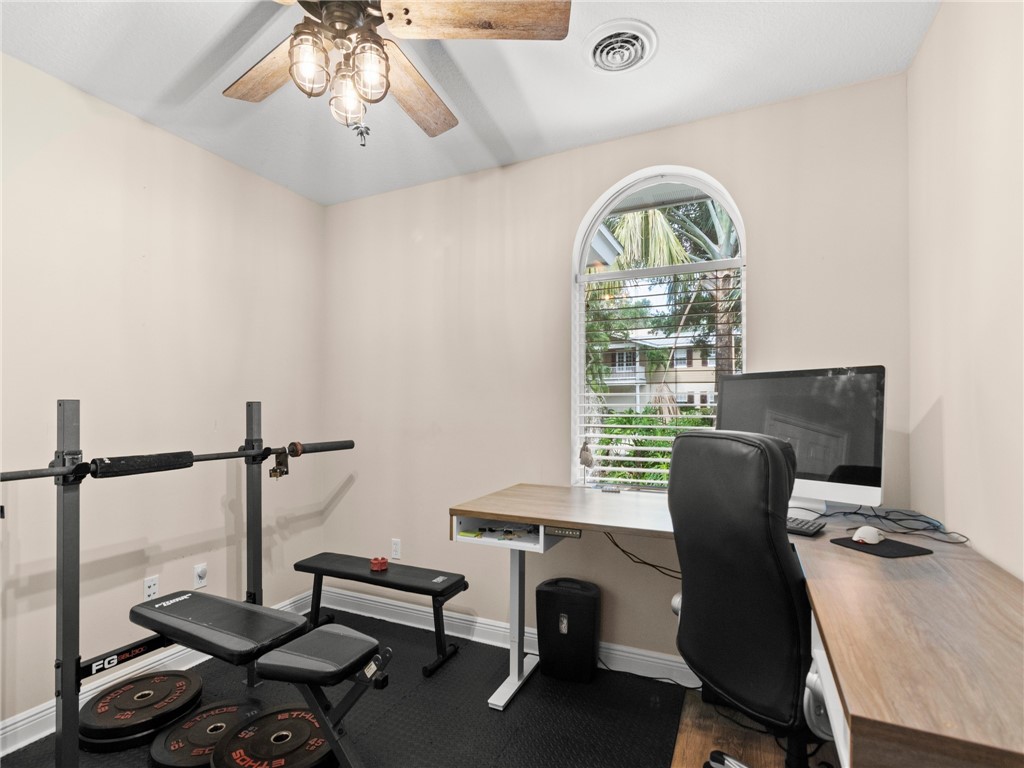 4676 Pebble Bay South, Unit BAY Vero Beach, FL 32963 - Photo 31 of 36 a view of a workspace with furniture and a window