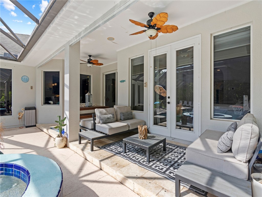 4676 Pebble Bay South, Unit BAY Vero Beach, FL 32963 - Photo 34 of 36 a living room with furniture potted plant and a large window