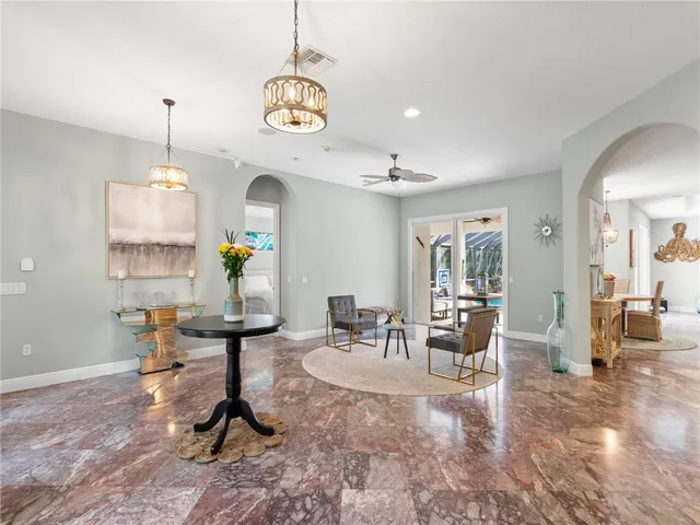 a living room with furniture chandelier and a chandelier
