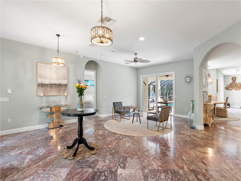 4676 Pebble Bay South, Unit BAY Vero Beach, FL 32963 - Photo 5 of 36 a living room with furniture chandelier and a chandelier