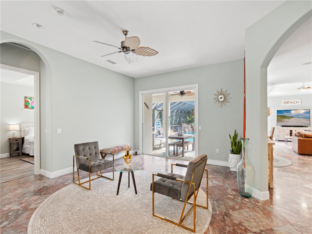 4676 Pebble Bay South, Unit BAY Vero Beach, FL 32963 - Photo 6 of 36 a view of a dining room with furniture and a chandelier