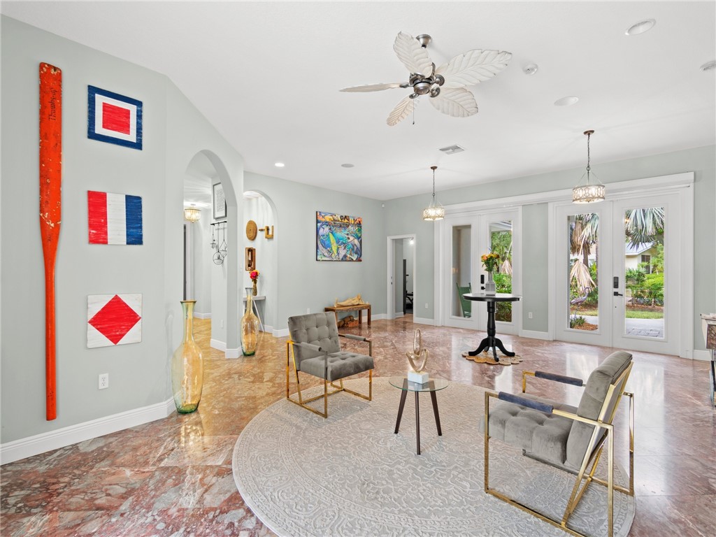 4676 Pebble Bay South, Unit BAY Vero Beach, FL 32963 - Photo 8 of 36 a living room with furniture and a chandelier