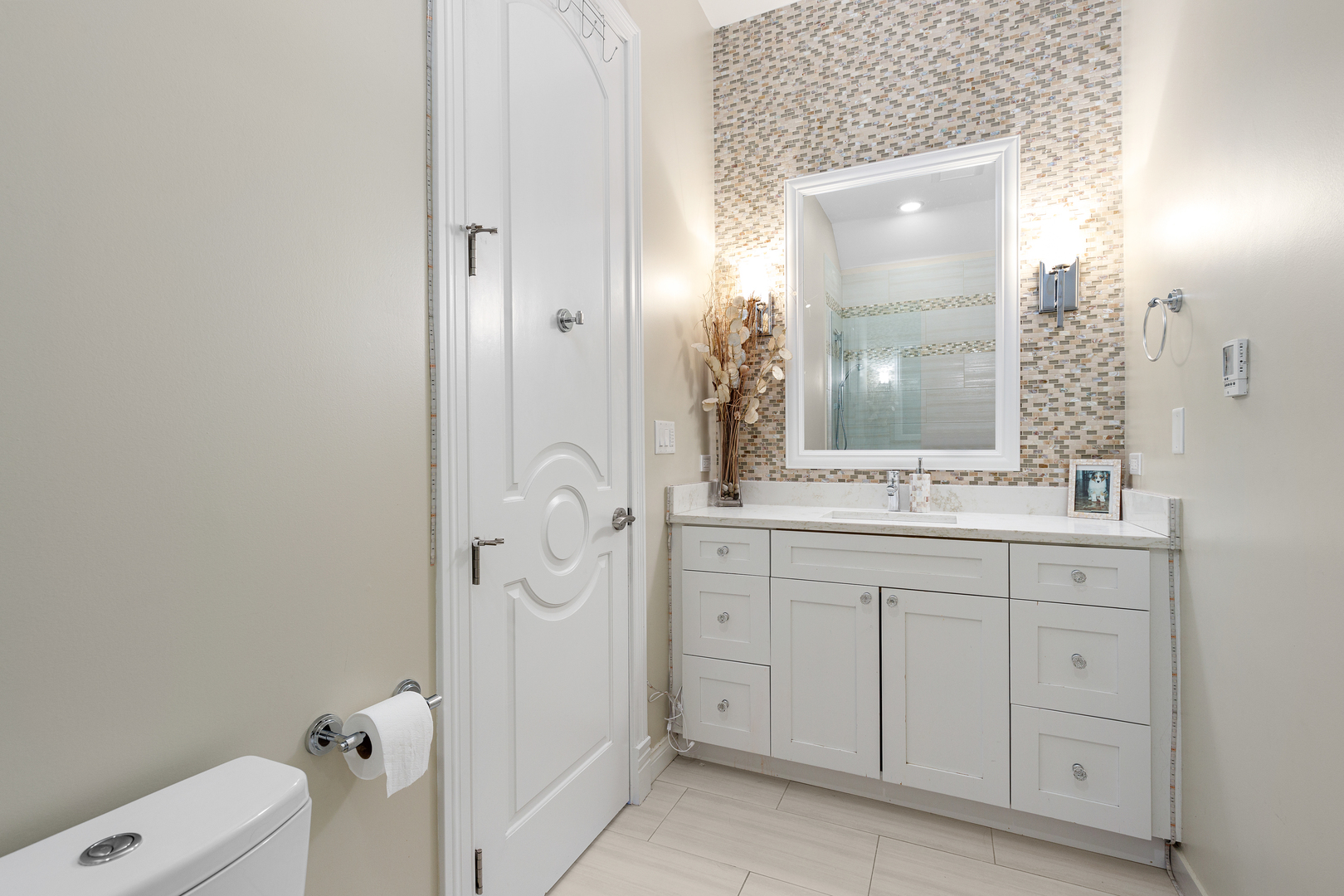 Undisclosed Address Chicago, IL 60657 - Photo 2 of 52 a bathroom with a double vanity sink and mirror with toilet