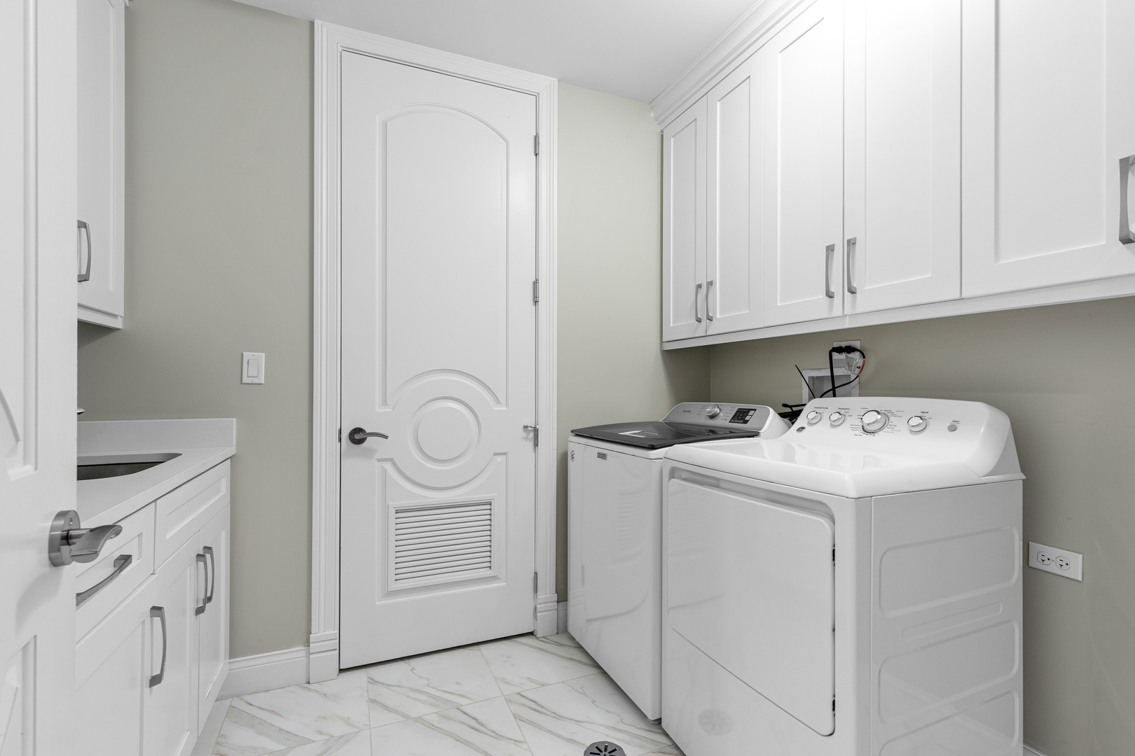 Undisclosed Address Chicago, IL 60657 - Photo 39 of 52 a utility room with cabinets washer and dryer