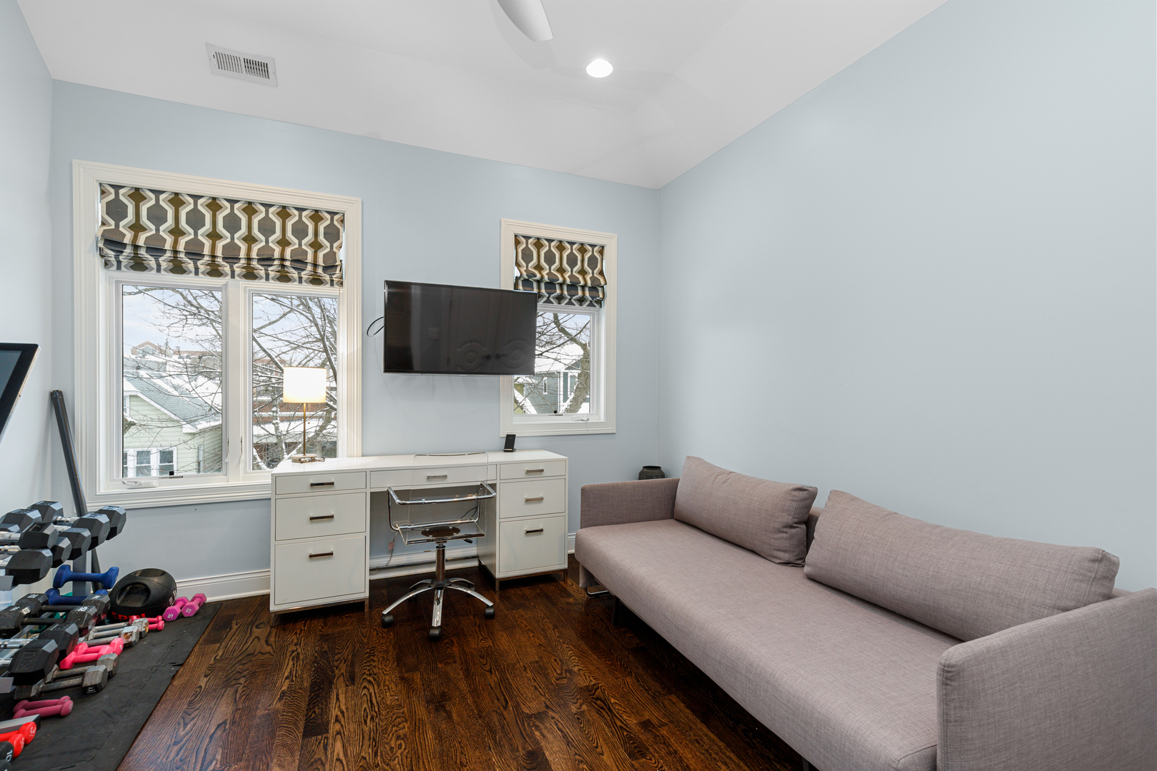 Undisclosed Address Chicago, IL 60657 - Photo 49 of 52 a work room with furniture a flat screen tv and a large window