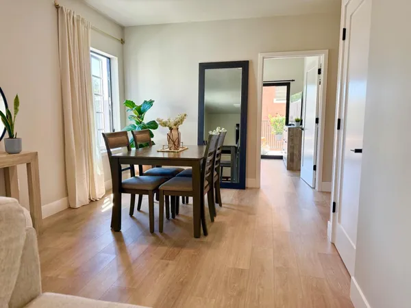 a view of a dining room with furniture and wooden floor