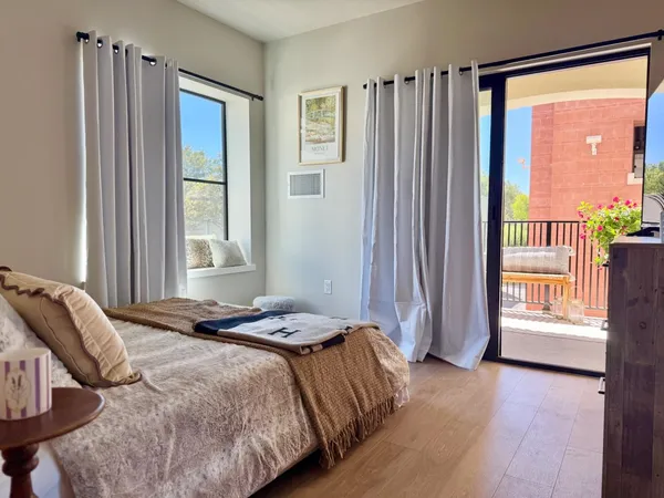 a bedroom with a bed and a window