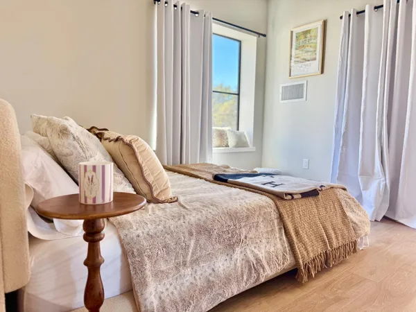 a bedroom with a bed and a window