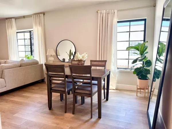 a dining room with furniture and wooden floor