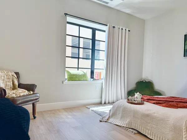 a bedroom with a bed and a window