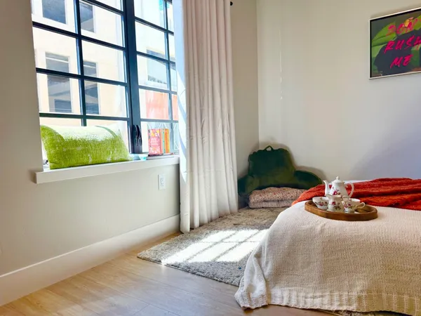 a bedroom with a bed and a window