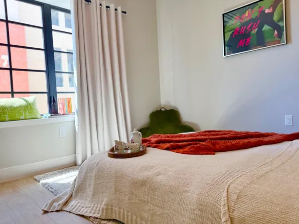 a bedroom with a bed and a window