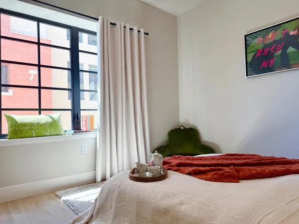 a bedroom with a bed and a window