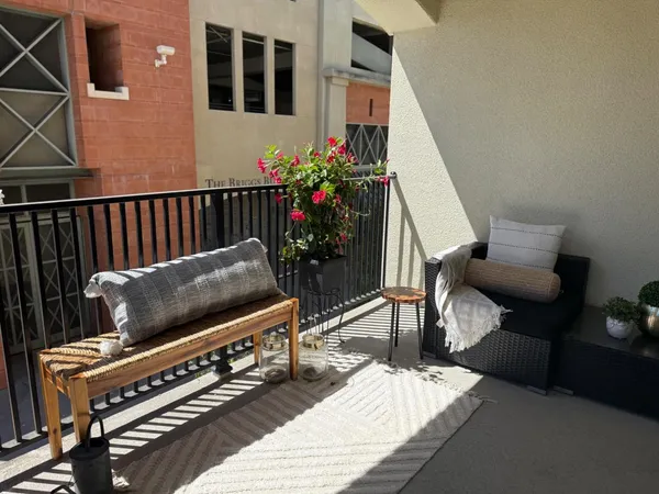 a living room with furniture and flowers