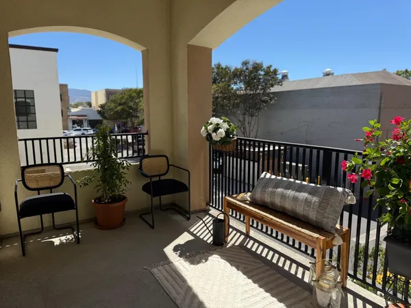 a view of a balcony with furniture