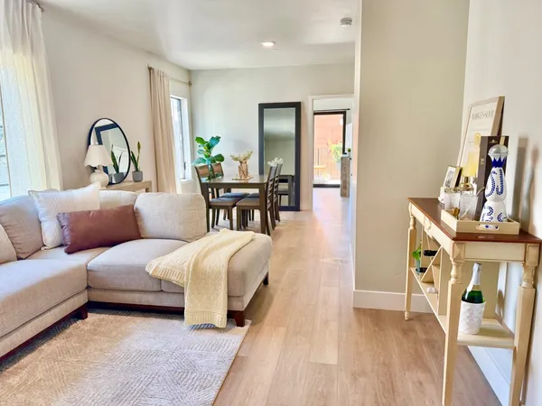 a living room with furniture a flat screen tv and a large window