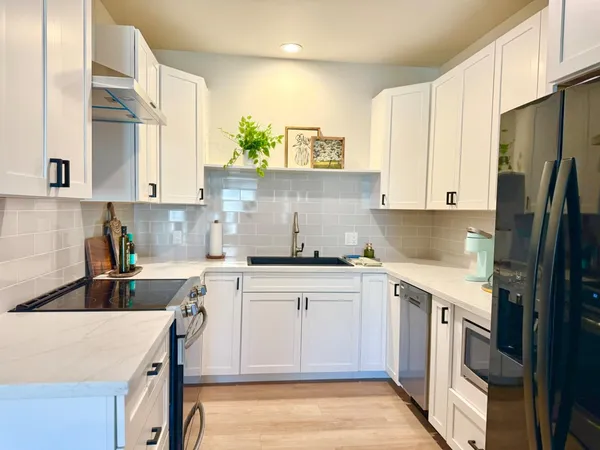 a kitchen with a sink stove and refrigerator