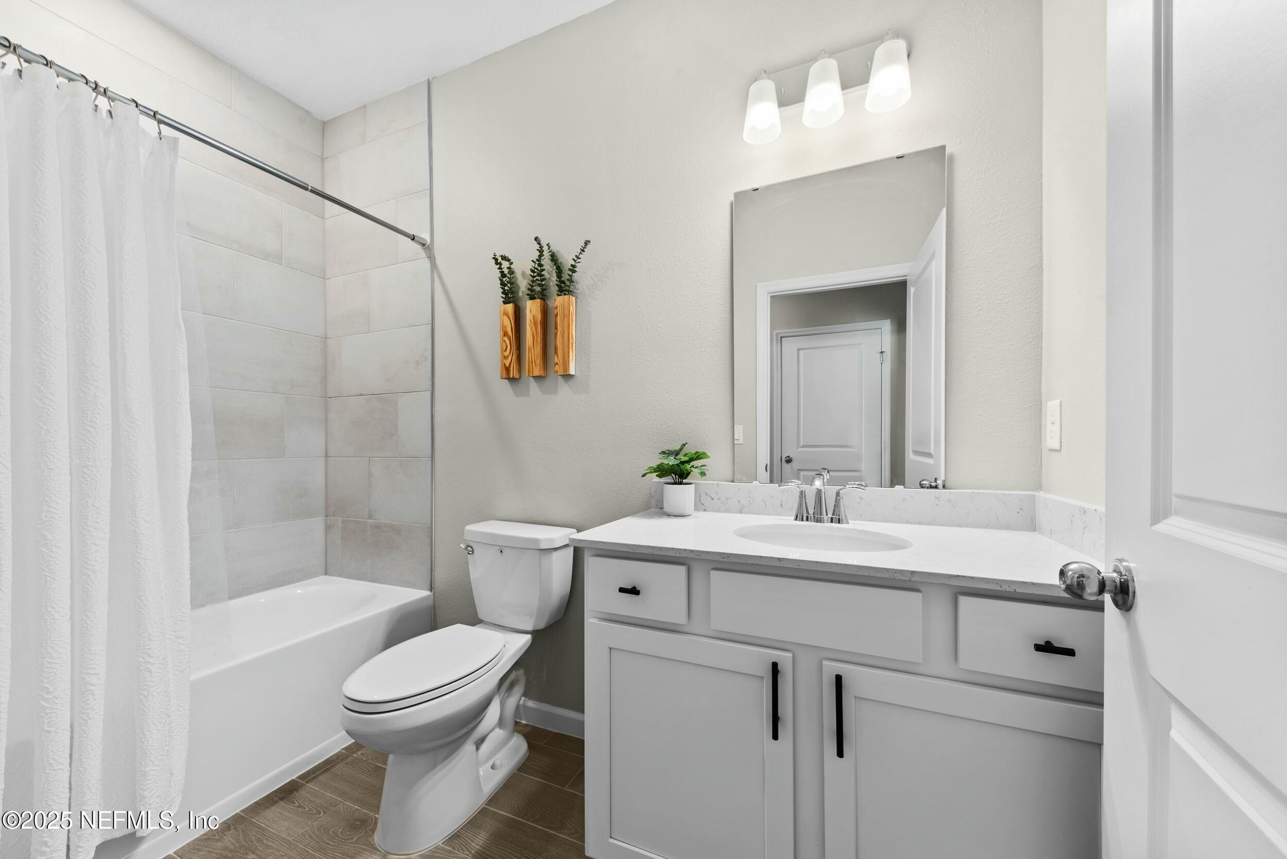 71 Blue Cypress Trail St. Augustine, FL 32084 - Photo 20 of 28 a bathroom with a sink a toilet and shower