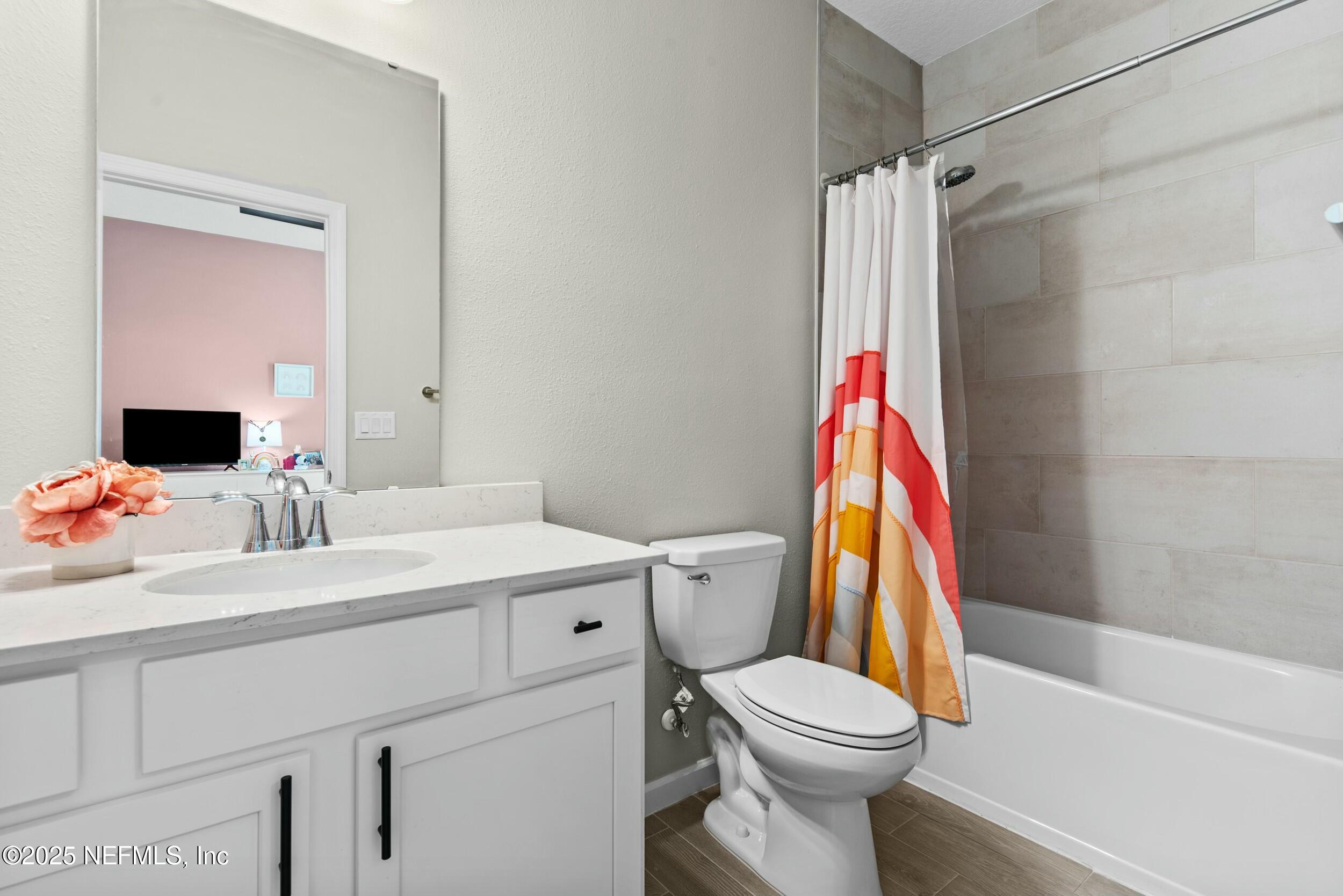 71 Blue Cypress Trail St. Augustine, FL 32084 - Photo 23 of 28 a bathroom with a sink vanity mirror and toilet