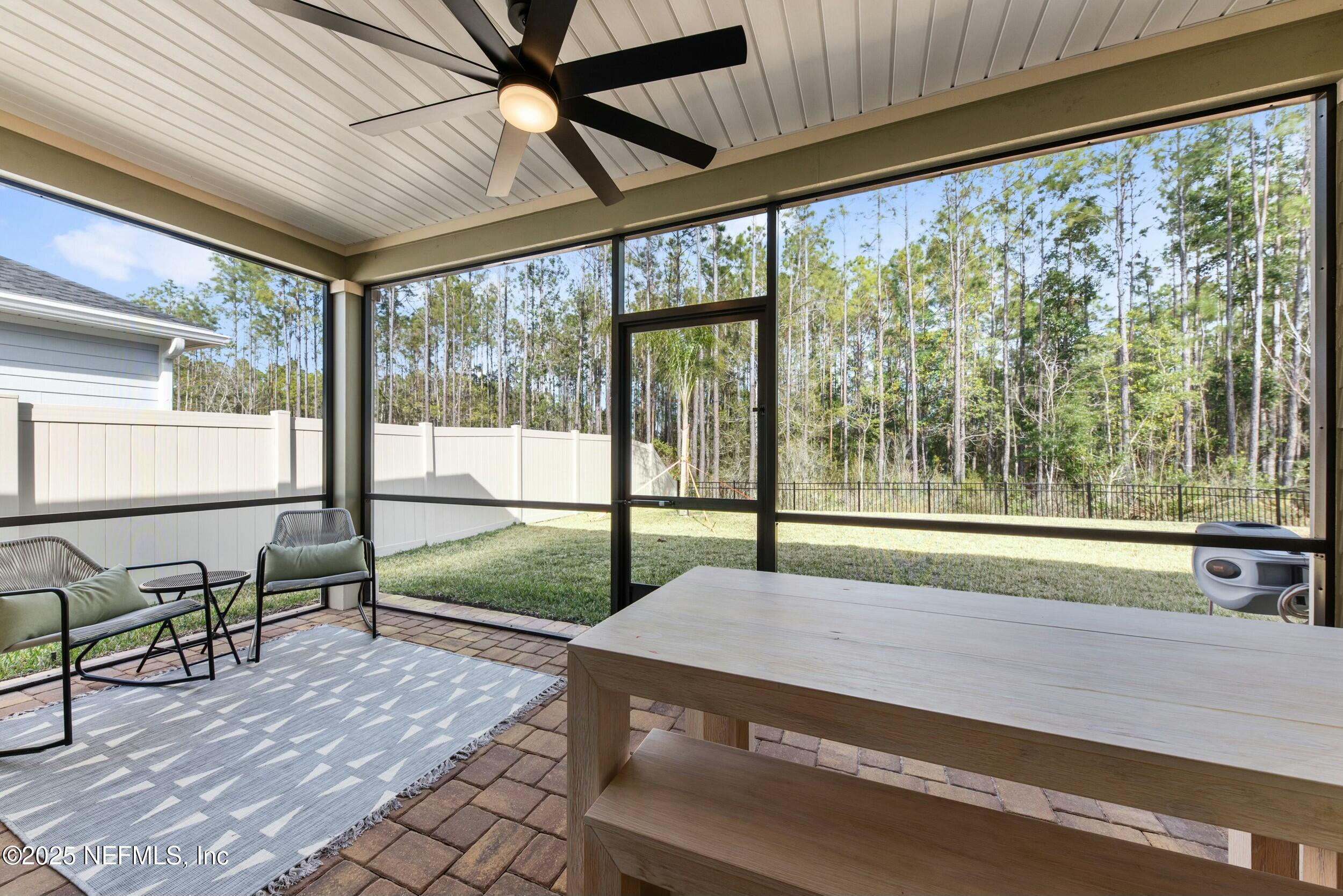 71 Blue Cypress Trail St. Augustine, FL 32084 - Photo 25 of 28 a living room with a floor to ceiling windows and pool table