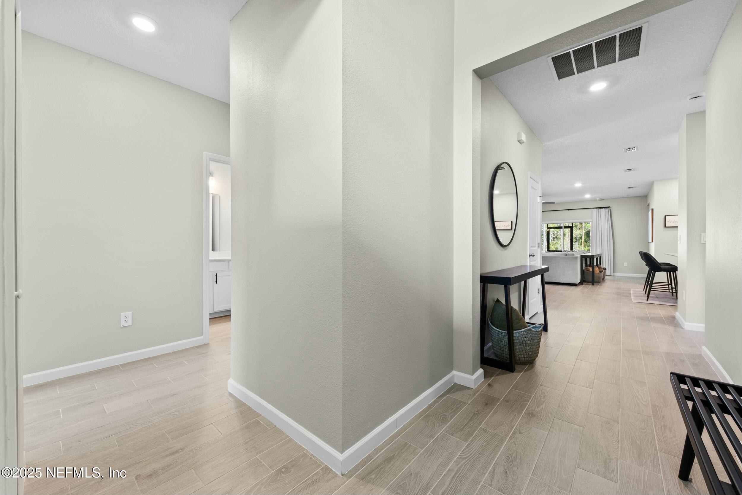 71 Blue Cypress Trail St. Augustine, FL 32084 - Photo 5 of 28 a view of a hallway with wooden floor and furniture