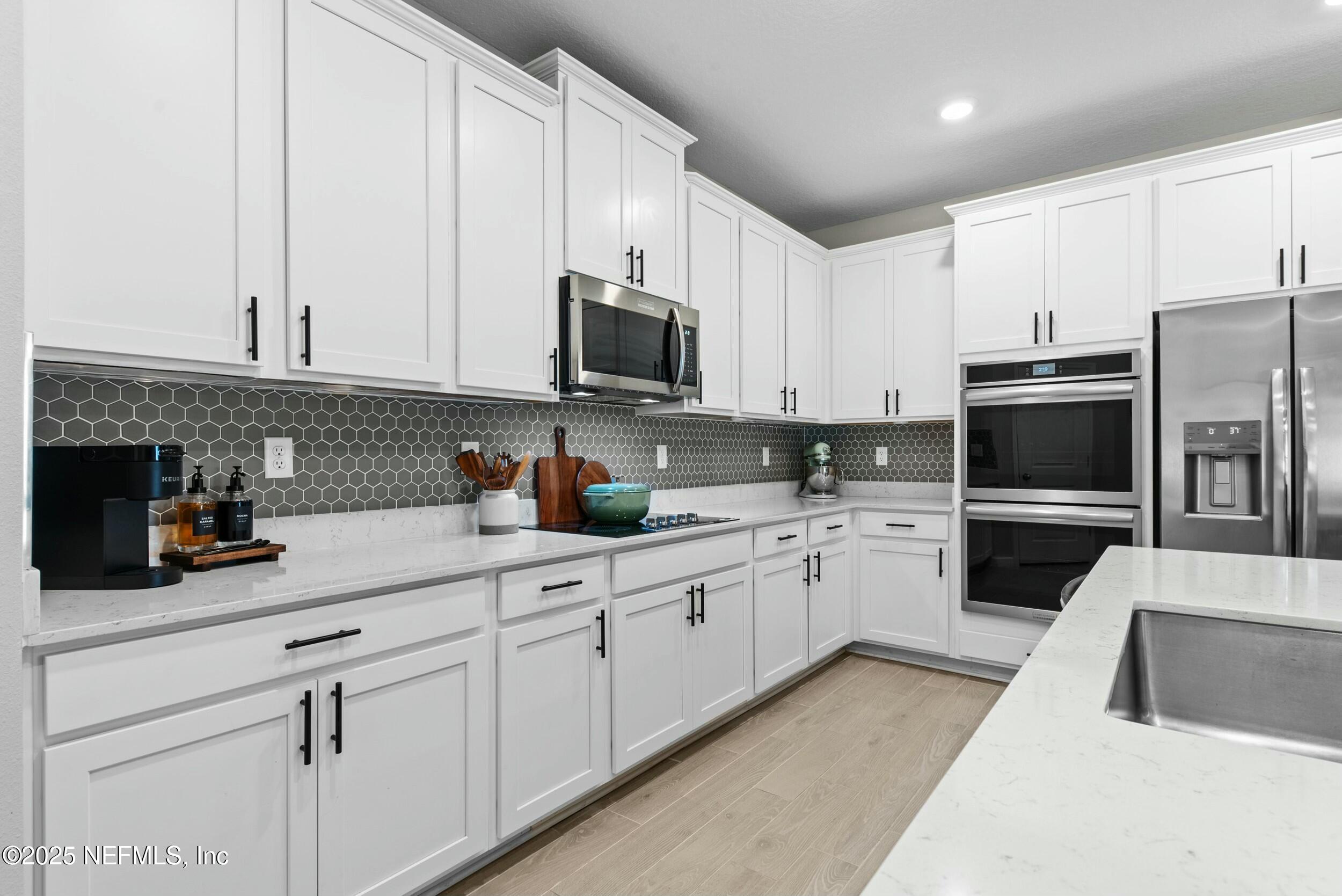 71 Blue Cypress Trail St. Augustine, FL 32084 - Photo 9 of 28 a kitchen with cabinets stainless steel appliances and a counter space