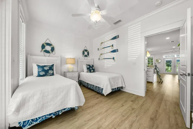 a kitchen with stainless steel appliances granite countertop a refrigerator a sink dishwasher a oven and a dining table with wooden floor