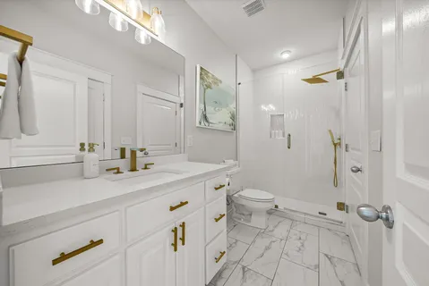 a kitchen with kitchen island a stove a refrigerator a sink and dishwasher with wooden floor