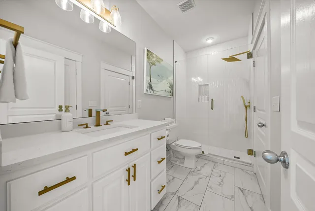 a kitchen with kitchen island a stove a refrigerator a sink and dishwasher with wooden floor