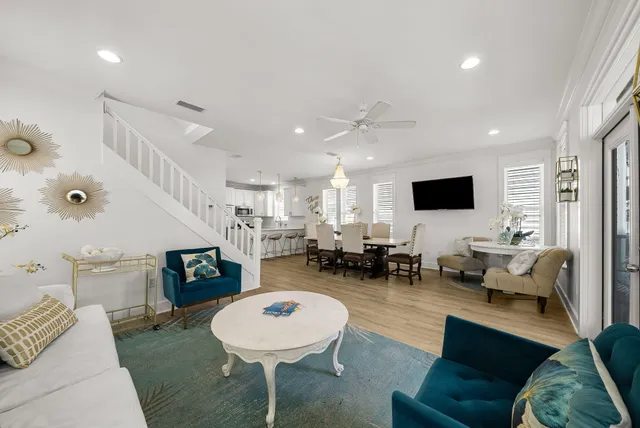 a living room with a bed and wooden floor