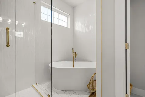 a bedroom with a bed and a flat tv screen on dresser