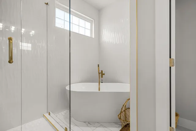 a bedroom with a bed and a flat tv screen on dresser