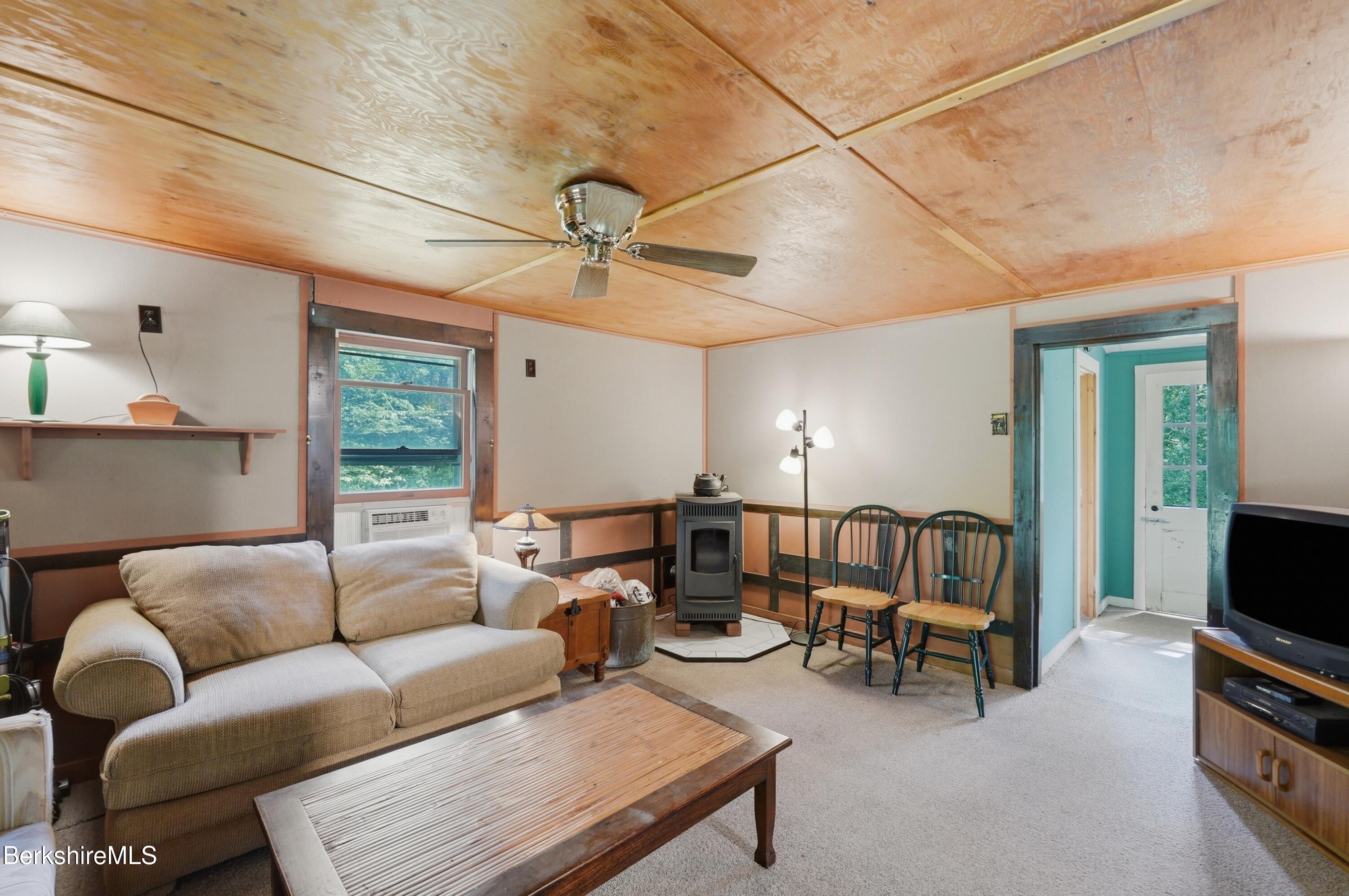 68 Curtin Road Peru, MA 01235 - Photo 27 of 38 a living room with furniture and a flat screen tv