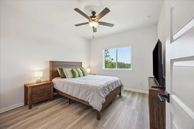 a bedroom with a bed tv and a window