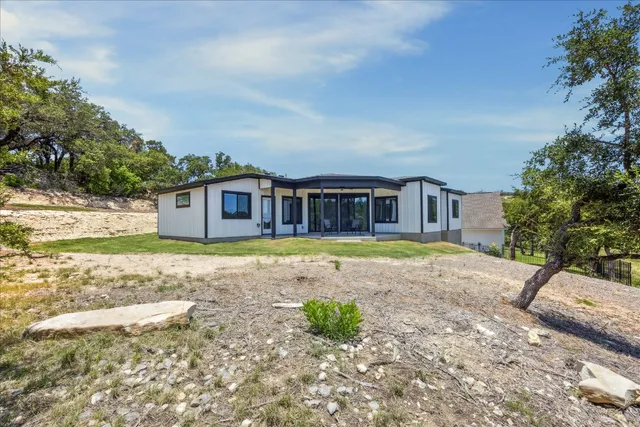 a view of house with backyard and swimming pool