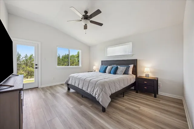 a bedroom with a large bed and a window