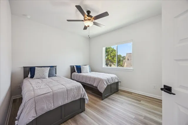 a bedroom with two beds and a window
