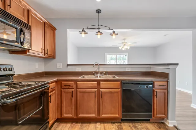 a kitchen with a sink stove and microwave