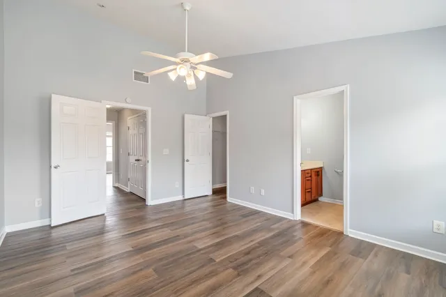 a view of an empty room with wooden floor
