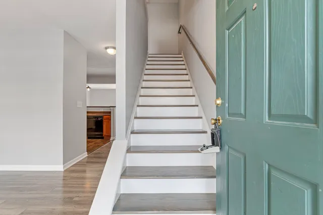 a view of entryway and hall with wooden floor