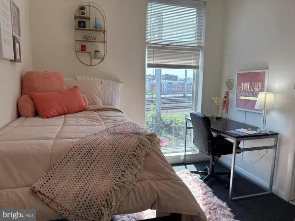 a bedroom with a bed and a desk