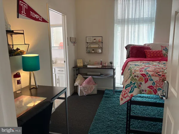 a bedroom with a bed and window