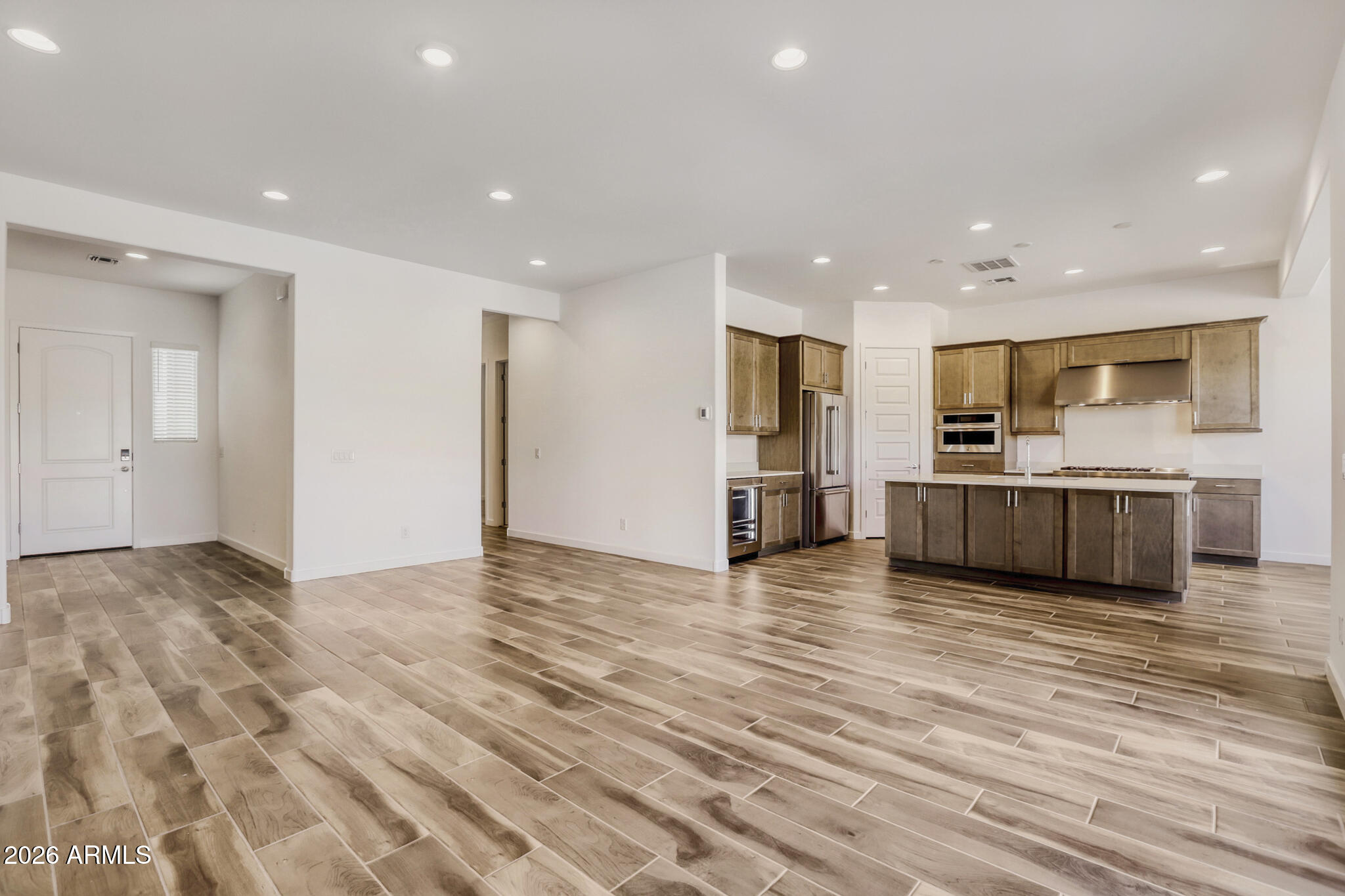 7954 West Rowel Road Peoria, AZ 85383 - Photo 10 of 31 a view of kitchen with kitchen island granite countertop stainless steel appliances refrigerator oven stove microwave and cabinets