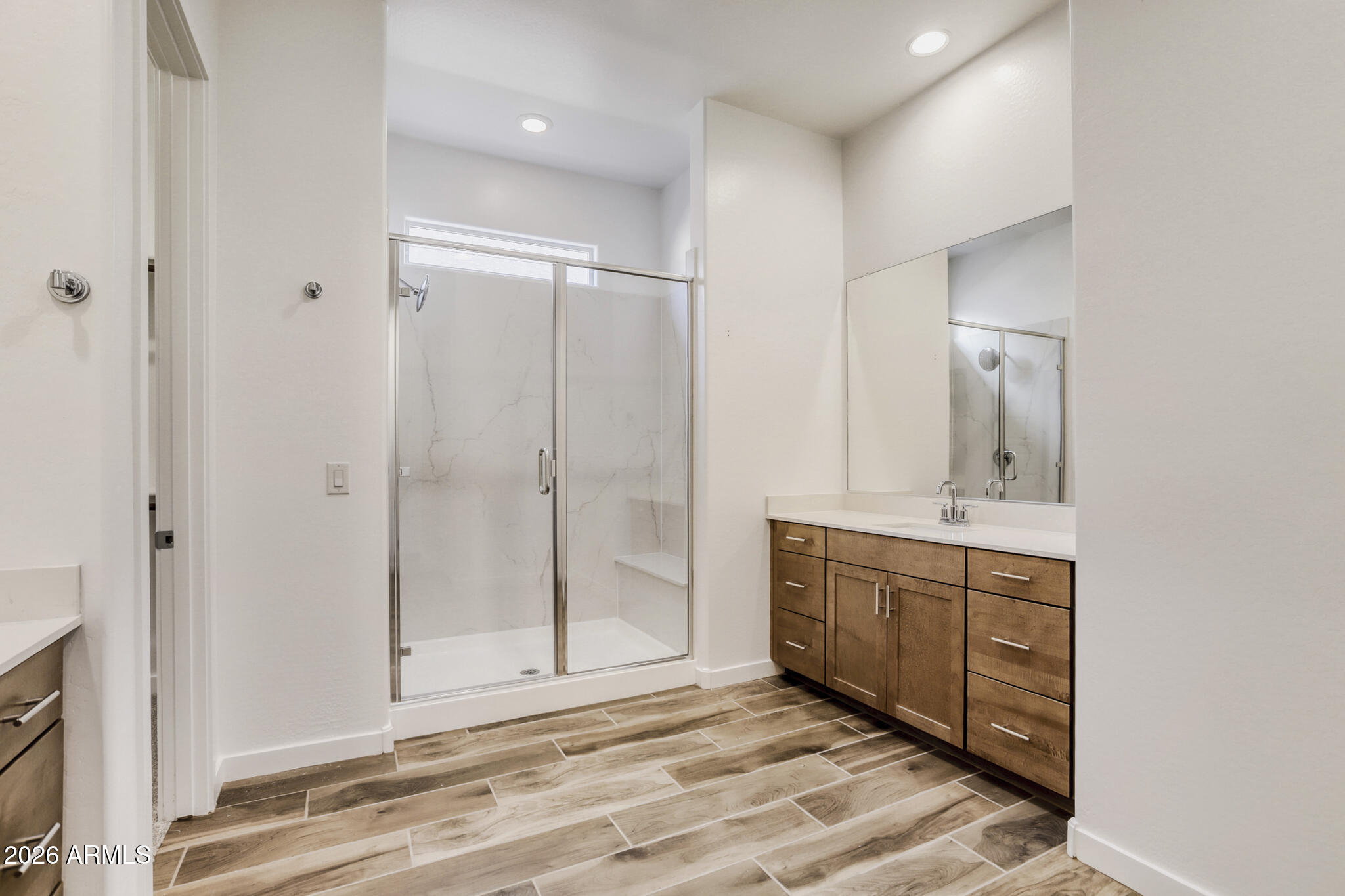 7954 West Rowel Road Peoria, AZ 85383 - Photo 14 of 31 a view of a bathroom with mirror and shower