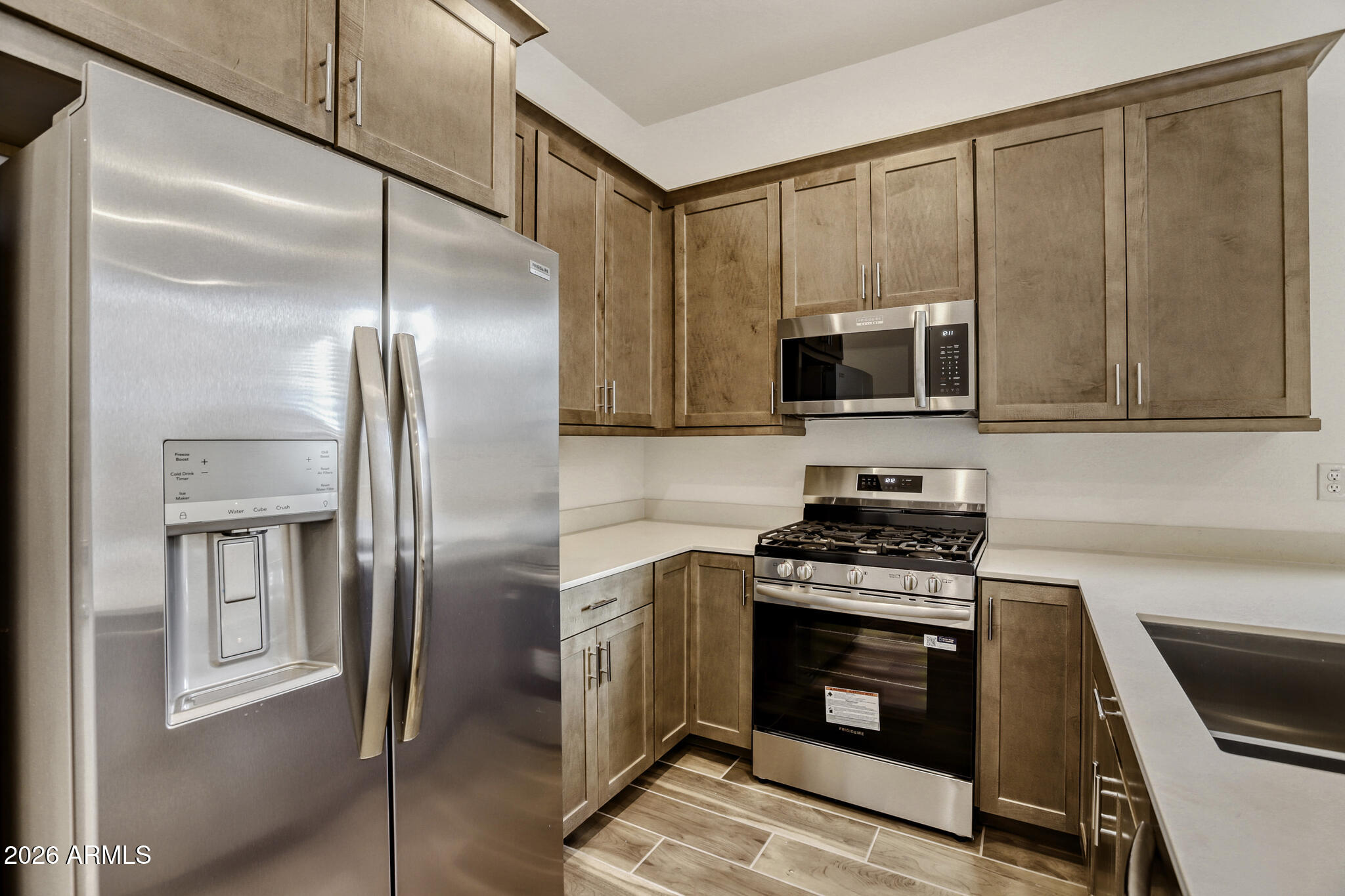7954 West Rowel Road Peoria, AZ 85383 - Photo 16 of 31 a kitchen with stainless steel appliances granite countertop a stove a refrigerator and a microwave