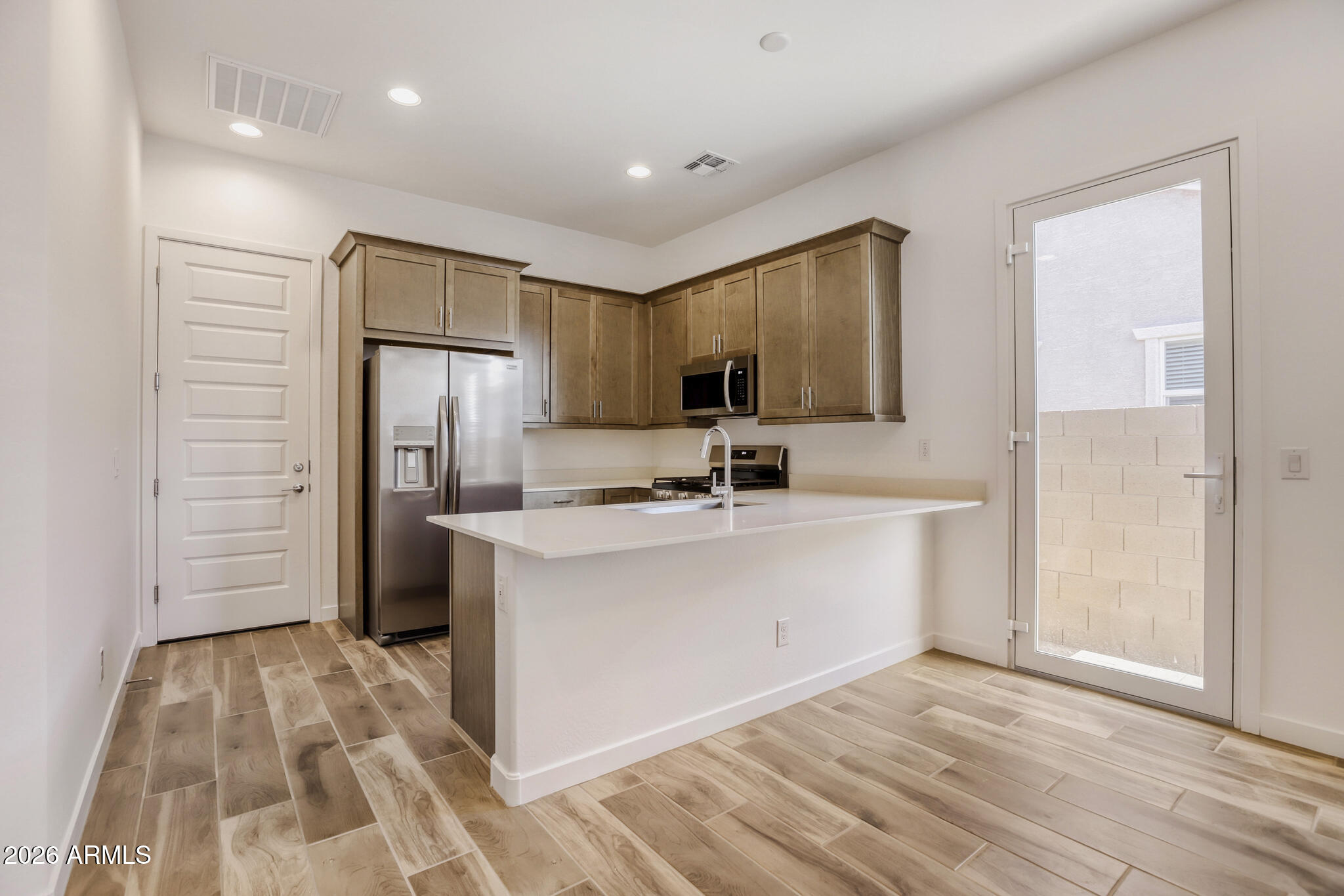 7954 West Rowel Road Peoria, AZ 85383 - Photo 18 of 31 a view of kitchen with refrigerator and window