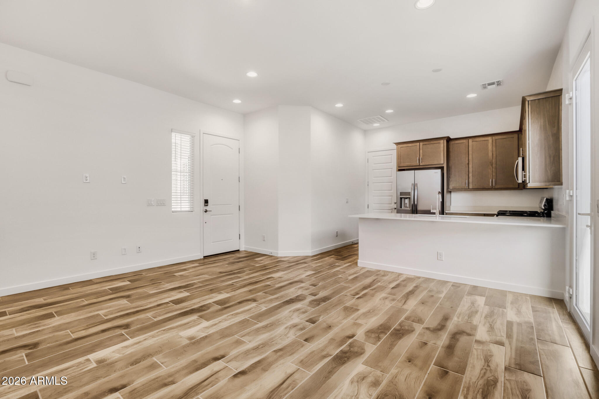 7954 West Rowel Road Peoria, AZ 85383 - Photo 20 of 31 a view of a kitchen with kitchen island a sink stainless steel appliances and cabinets