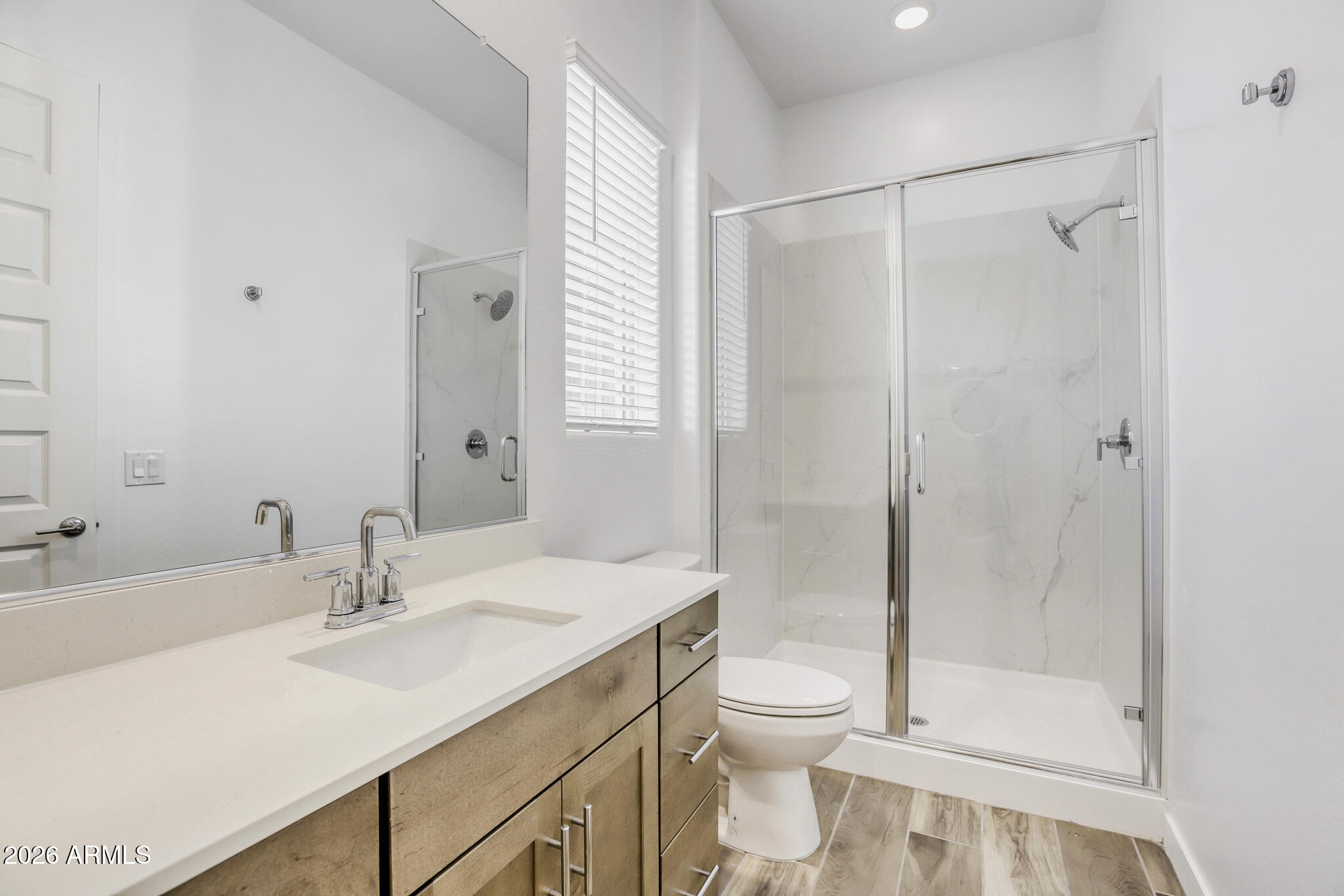 7954 West Rowel Road Peoria, AZ 85383 - Photo 22 of 31 a bathroom with a shower sink vanity mirror and toilet